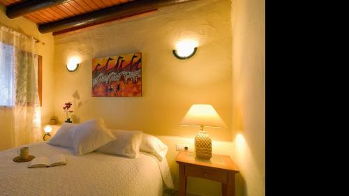 a bedroom with a bed and a lamp on a table at Apartment Punta di Mare Punta Mujeres By PVL in Punta de Mujeres