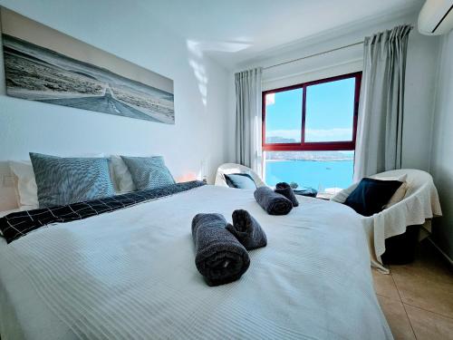 a bedroom with a large bed with towels on it at Residence Ocean View in Mogán