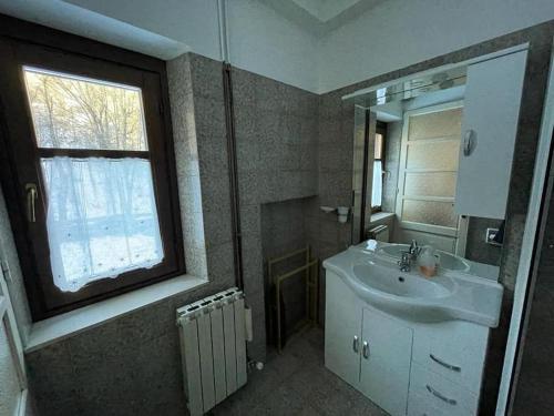 a bathroom with a sink and a window at Villa Gatti [Limone Centro] in Limone Piemonte