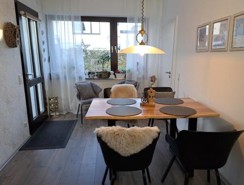 a dining room with a wooden table and chairs at Ferienwohnung Prinz in Lindlar