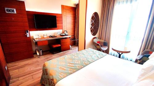 a hotel room with a bed and a desk at Old Port Hotel in Istanbul