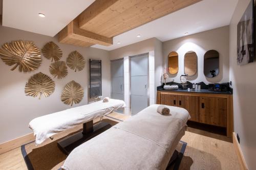 2 camas de masaje en una habitación con lavabo en CGH Résidences & Spas Alpaga en La Toussuire