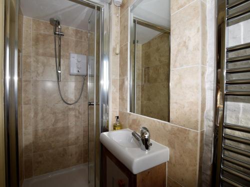 a bathroom with a sink and a shower at 1 Bed in Isle of Purbeck IC131 in Worth Matravers