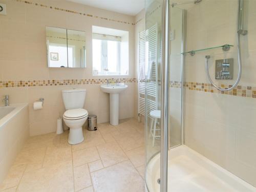 a bathroom with a toilet and a shower and a sink at 2 Bed in Harrogate District HH087 in Stainburn