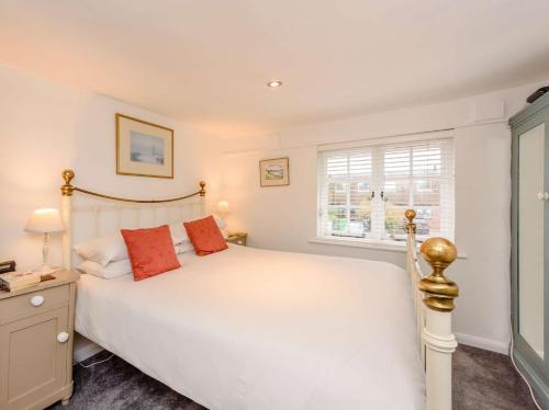 a bedroom with a white bed and a window at 1 Bed in Tenterden 66342 in Tenterden
