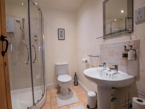 a bathroom with a shower and a sink and a toilet at 1 bed in Bedale G0094 in Crakehall