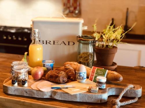 a cutting board with different types of food on a table at Gîte "La belle vie" in Chamblet