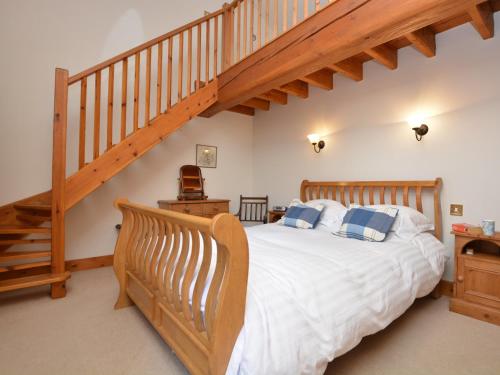 sypialnia z drewnianym łóżkiem i schodami w obiekcie 1 Bed in Lincoln 73852 w mieście East Barkwith