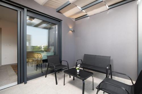 a room with a table and chairs and a dining room at Villa Tiki in Medulin for 16 person with heated pool & sauna only 1 km from the beach in Medulin