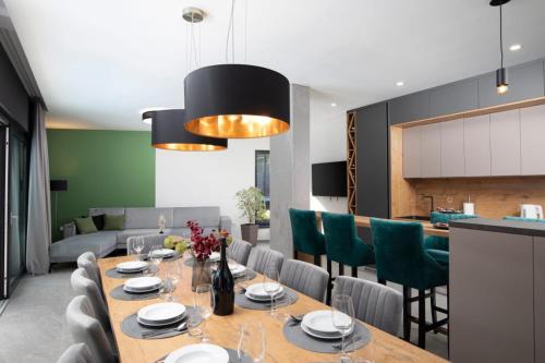 a dining room with a table and chairs at Villa Tiki in Medulin for 16 person with heated pool & sauna only 1 km from the beach in Medulin