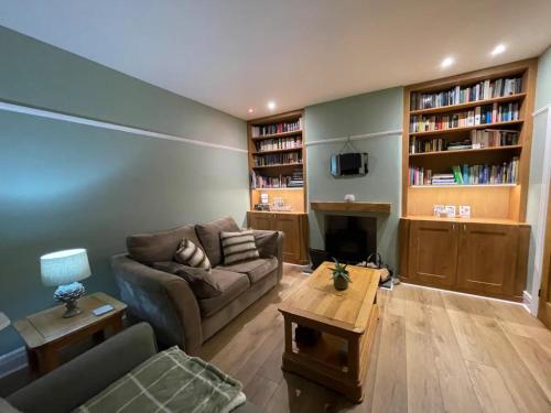 a living room with a couch and a table at Glossop Retreat - Pet Friendly Perfect for 6 in Glossop