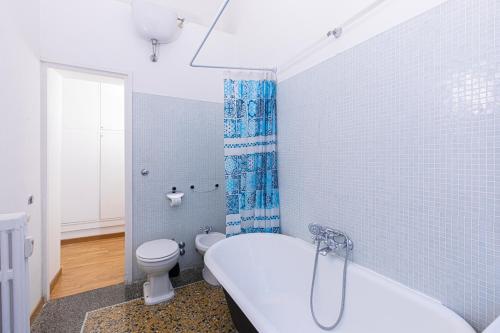 a bathroom with a white tub and a toilet at Antonelli Place in Rome