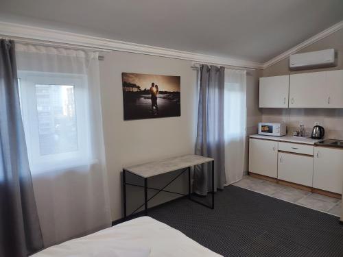 a kitchen with a bed and a table in a room at City Club European in Chernivtsi