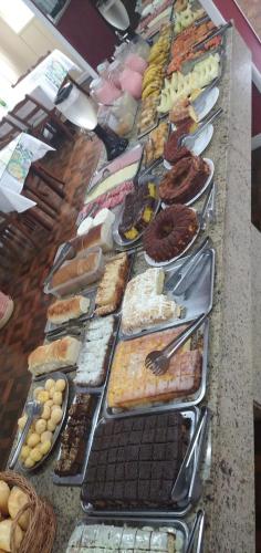 a buffet line with many different types of pastries at Grande Hotel Torres in Torres