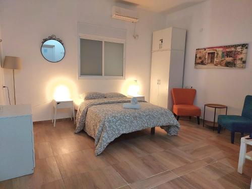 a bedroom with a bed and a table with two lamps at Paradise in haifa near the bahai gardens in Haifa