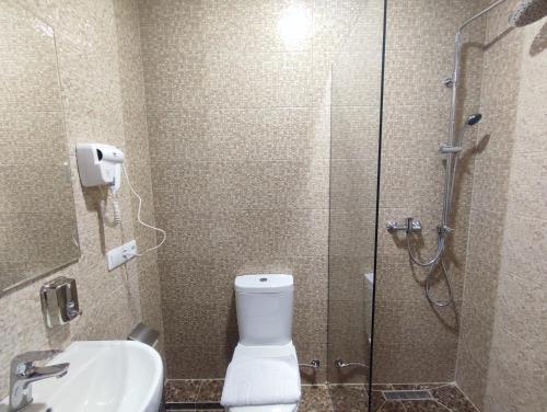 a bathroom with a shower and a toilet and a sink at City Club European in Chernivtsi