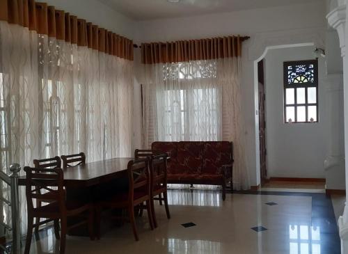 - une salle à manger avec une table, des chaises et un canapé dans l'établissement Party allowed Ja Ela Luxury entire home with 4 rooms, à Ja-Ela