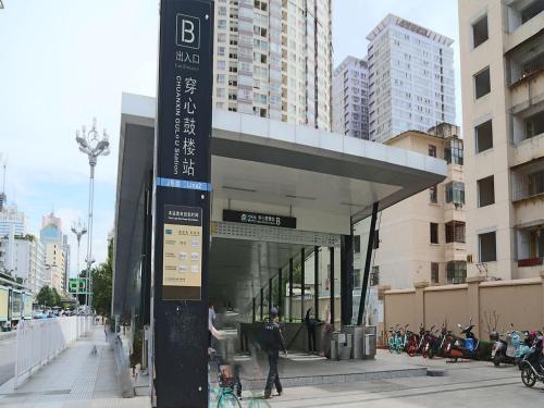 a sign for a bus stop in a city at Annie Apartment - only 120 metres from Metro Line 2 Exit B of Chuanxingulou in Kunming