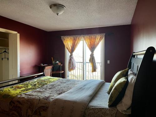 a bedroom with a large bed and a window at Beddington masteroom close airport! in Calgary