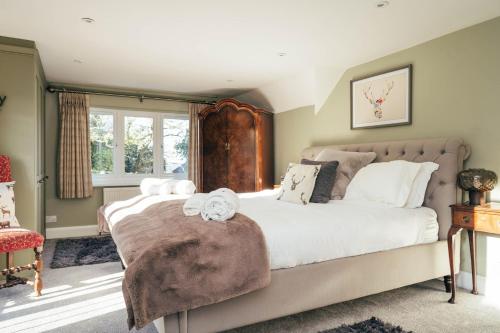 a bedroom with a large bed and a window at Broombank in Burley