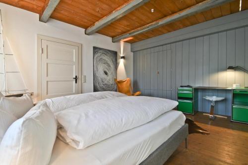 um quarto com uma grande cama branca num quarto em Kate 60 em Borkum