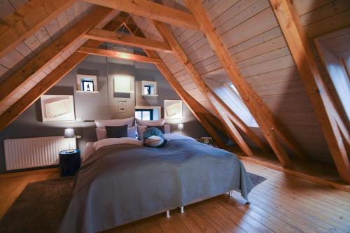 a bedroom with a large bed in a attic at Kate 60 - Suite Twee in Borkum