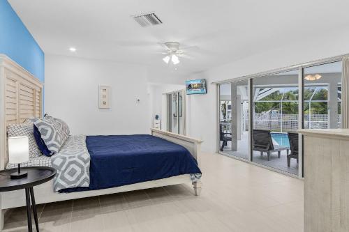 a bedroom with a bed and a view of a patio at Villa Island Pearl - Roelens Vacations in Sanibel