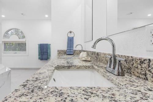 a kitchen with a sink and a counter top at Villa Island Pearl - Roelens Vacations in Sanibel