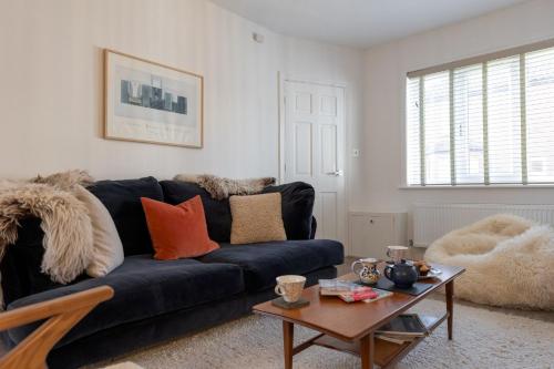 a living room with a blue couch and a table at 17 St Edmunds Road in Southwold