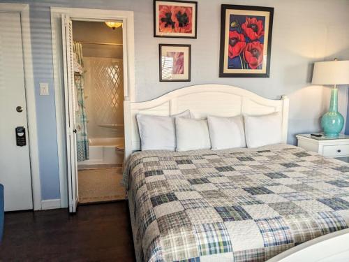 a bedroom with a bed with a checkered blanket at Chelsea Pub and Inn in Atlantic City