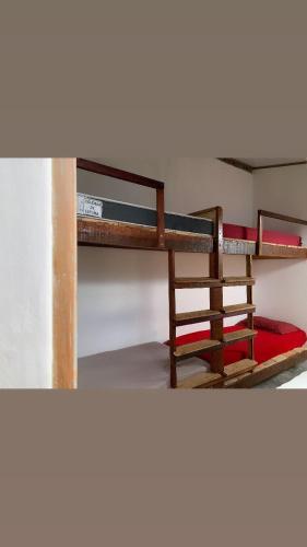 two bunk beds in a room with a red mattress at Hostel Paraguassú in Mucugê