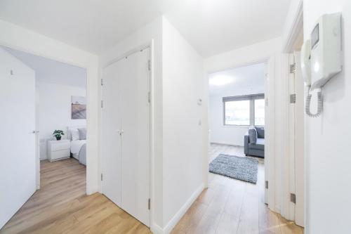 a white apartment with a hallway and a living room at St Pancras Residence 1 BR Flat Sleeps 4 in London