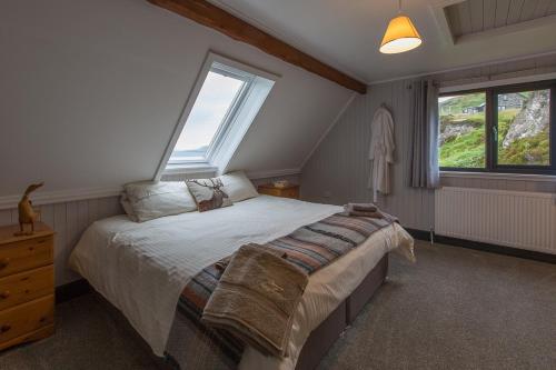 a bedroom with a large bed and a window at Doune Bay Lodge 