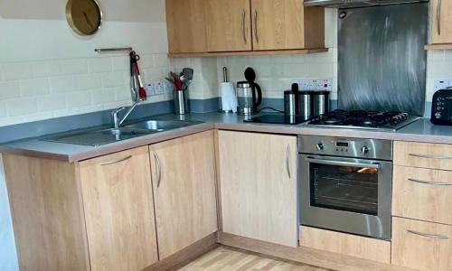a kitchen with a sink and a stove at City Centre Apartment - Sleeps 5 in Nottingham