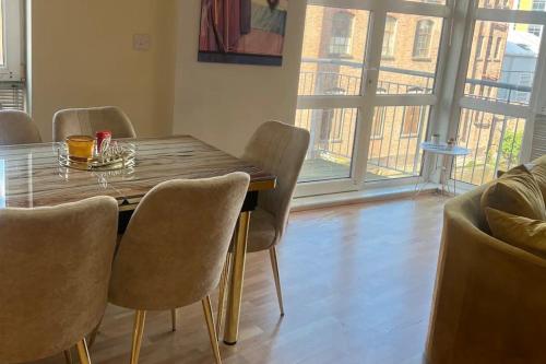 a dining room with a wooden table and chairs at City Centre Apartment - Sleeps 5 in Nottingham