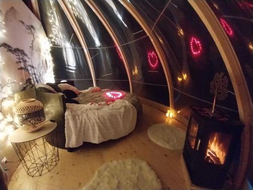a small room with a bed and a fireplace at Le Clos FMR Insolite - "F"anny Carcassonne in Malves-en-Minervois