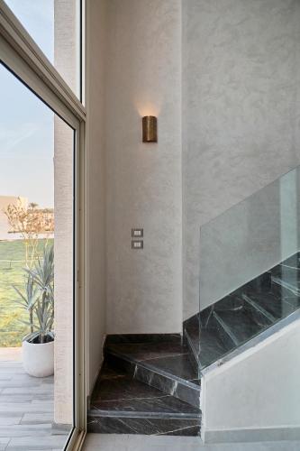 a fireplace in a room with a large window at True Beach Resort in Marsa Alam City