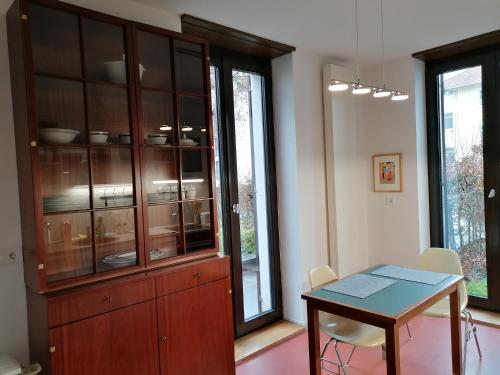 a kitchen with a wooden cabinet and a table and chairs at Architekten Villa in Theaternähe in Meiningen