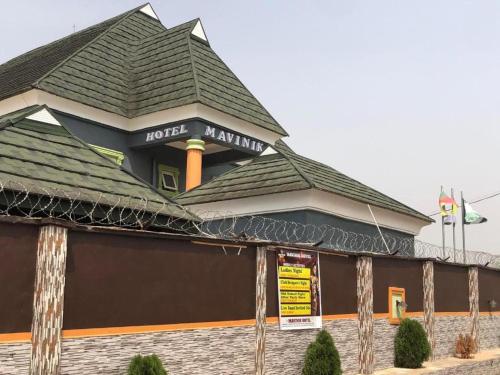 a building with a roof on top of it at MAVINIK'S (Ogun State) HOTEL, SUITES AND LOUNGE in Otta