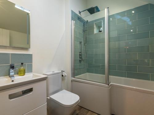 a bathroom with a shower and a toilet and a sink at 3 Bed in Bourton on the Water 75532 in Bourton on the Water
