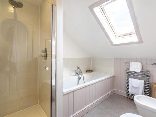 a bathroom with a bath tub and a sink at 5 bed property in Machrihanish CA291 in Machrihanish