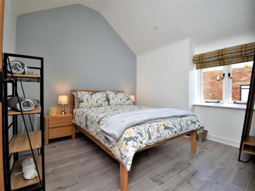 a bedroom with a bed and a window at 2 Bed in Wrexham 76399 in Coedpoeth