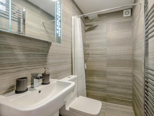 a bathroom with a sink and a toilet and a shower at 1 Bed in Flash 74351 in Flash