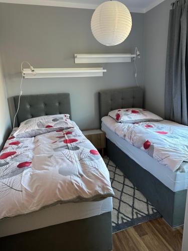 a bedroom with two beds and a lamp at Apartament Wałbrzych in Wałbrzych