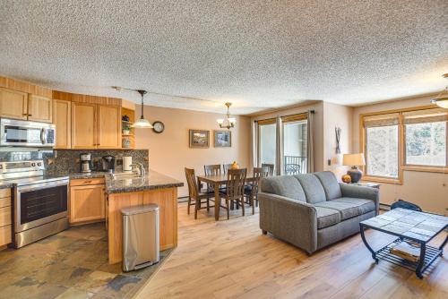 a kitchen and living room with a couch and a table at Ski-InandSki-Out Winter Park Condo with Mountain Views in Winter Park