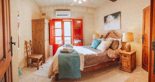 a bedroom with a bed and a table in it at Amaryllis Holiday Home in Qala