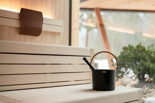 a bucket sitting on a table next to a window at Hotel Majon Miramonti in Canazei