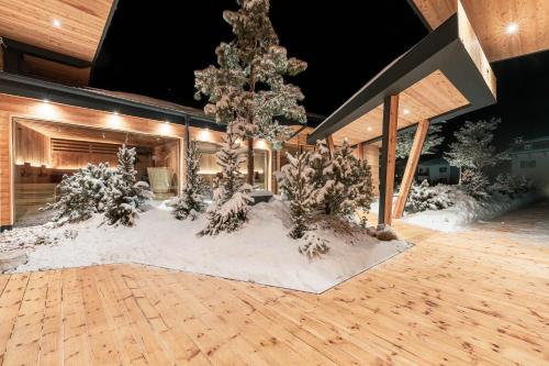 a room with snow on the floor and trees at Hotel Majon Miramonti in Canazei