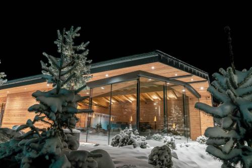 a building covered in snow at night at Hotel Majon Miramonti in Canazei