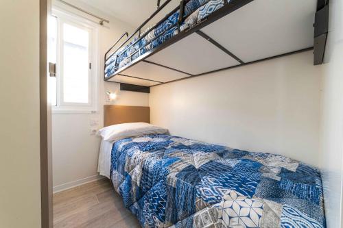 a bedroom with a bed and a bunk ladder at Centro Turistico San Nicola in Peschici